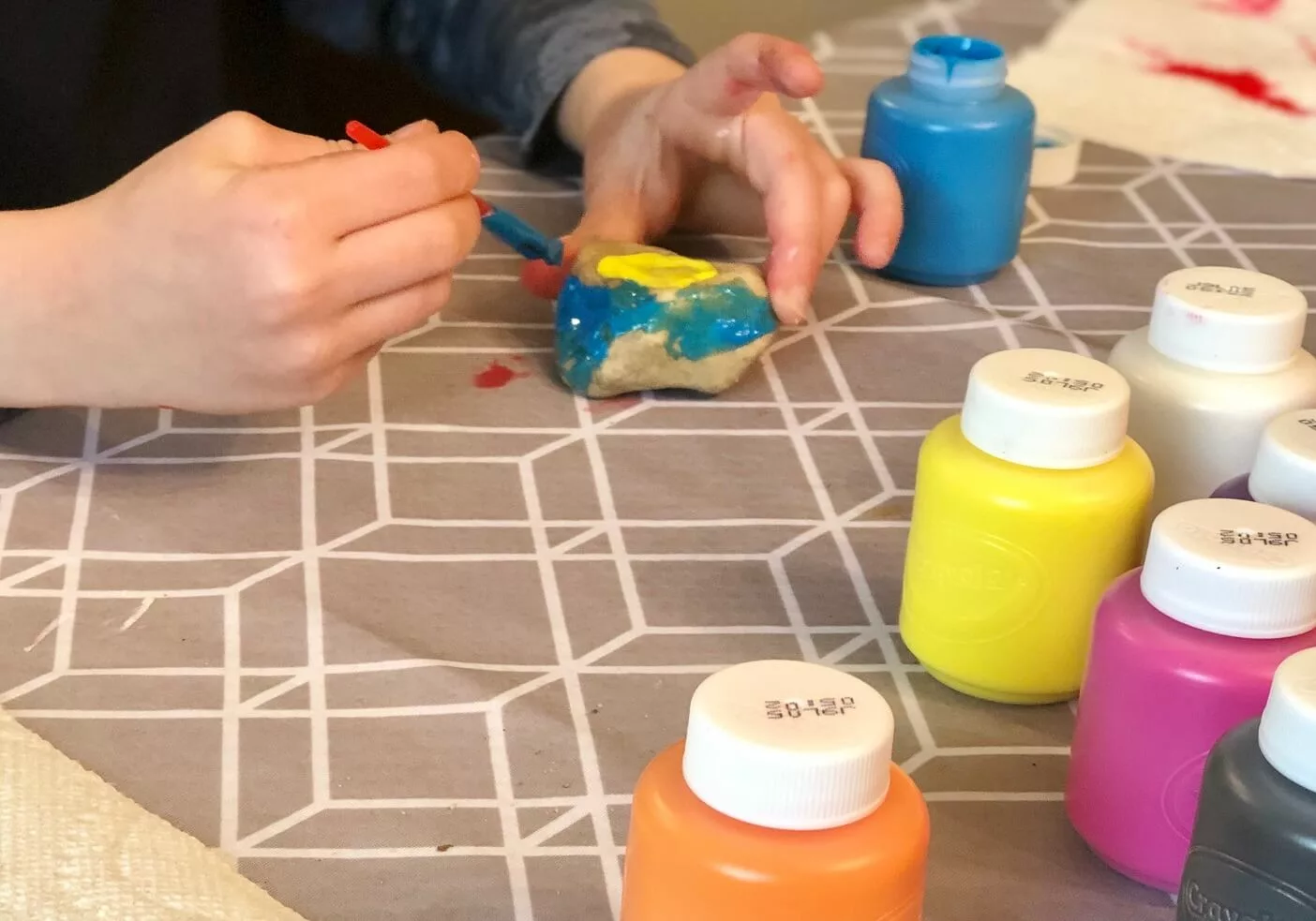 boy-painting-colorful-rocks-for-art-class-at-homes-2022-11-15-12-41-55-utc.jpg