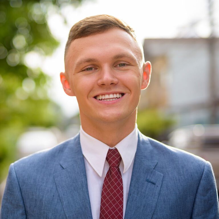 portrait-of-young-businessman-in-the-streets-outdo-ECXN8FS.jpg
